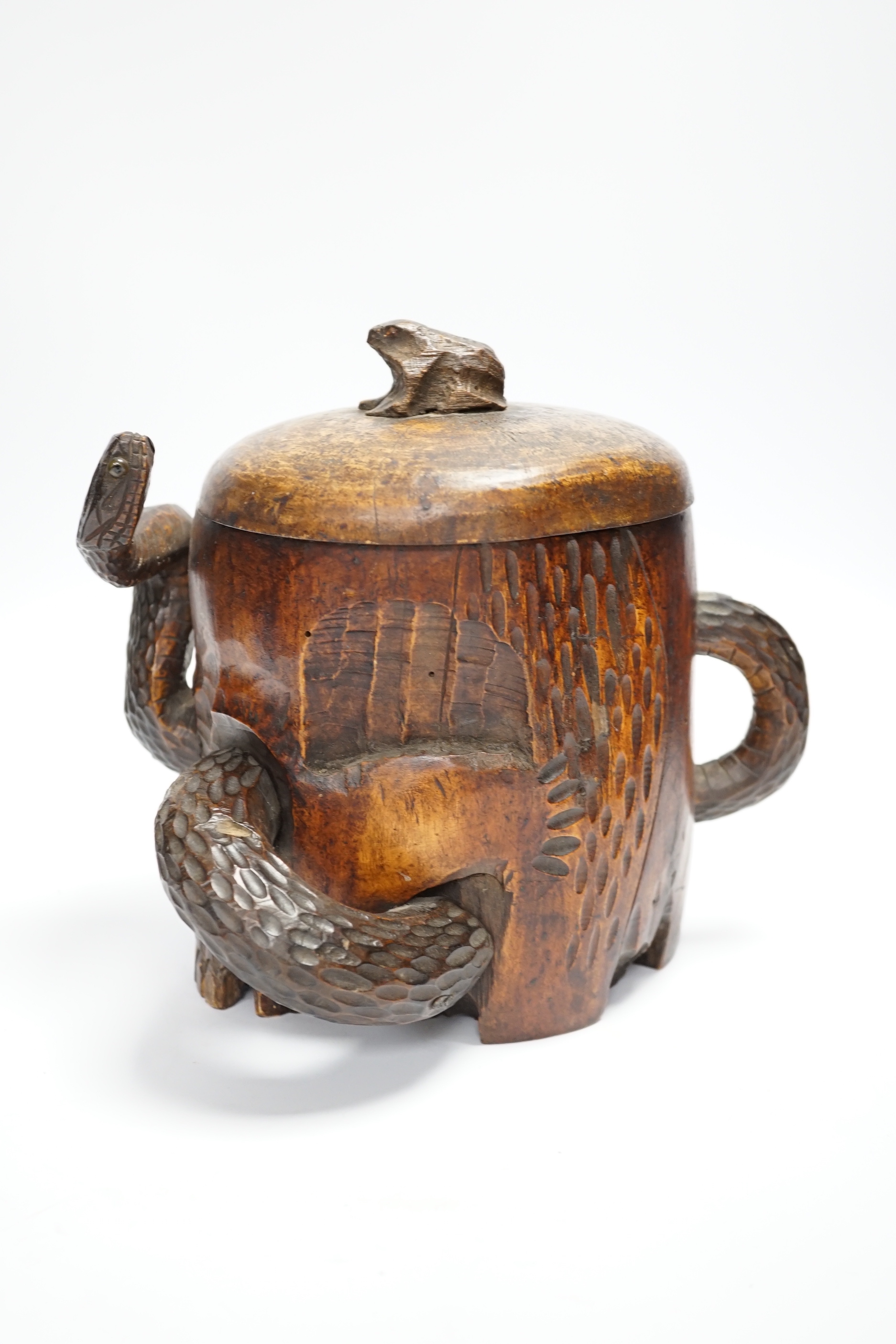 A Japanese carved wood tobacco jar in the form of a skull and snake, Meiji period, 21cm high